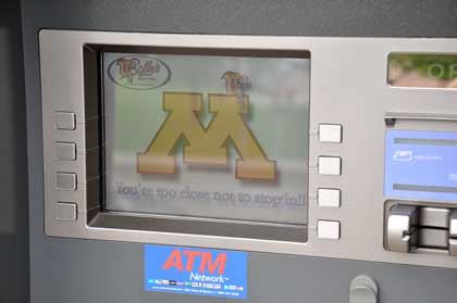 A customized ad screen encourages ATM users to stop inside.